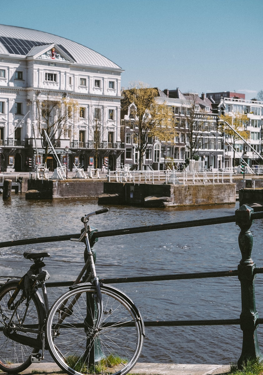 two bikes parked next to each other near a body of water